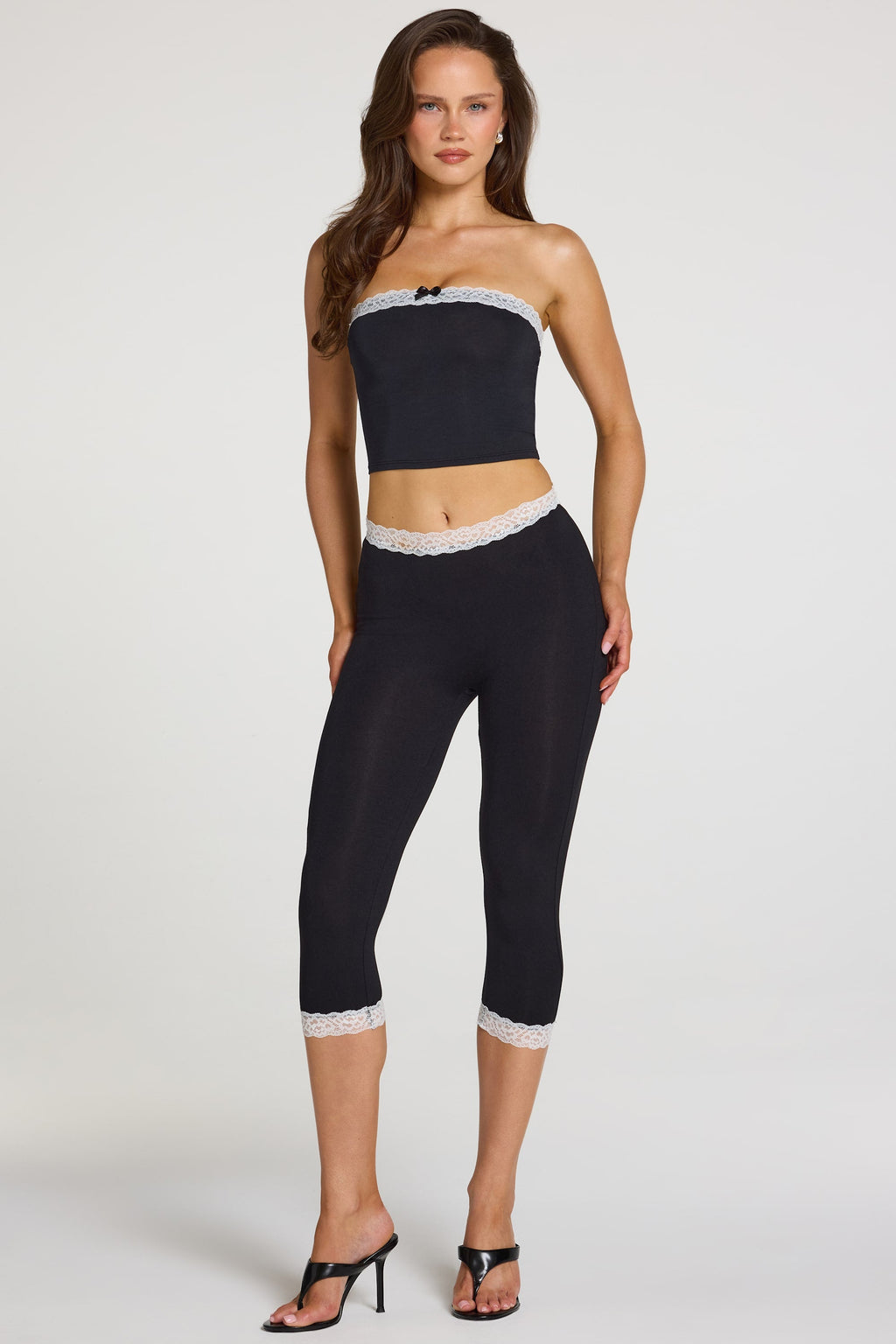 Modal Lace-Trim Mid-Rise Capri Leggings in Black — on model, front
