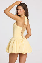 Lace-Up Bubble Hem Corset Mini Dress in Butter Yellow — back view, halter tie detail