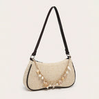 Florence pearl charm shoulder bag in black — on model