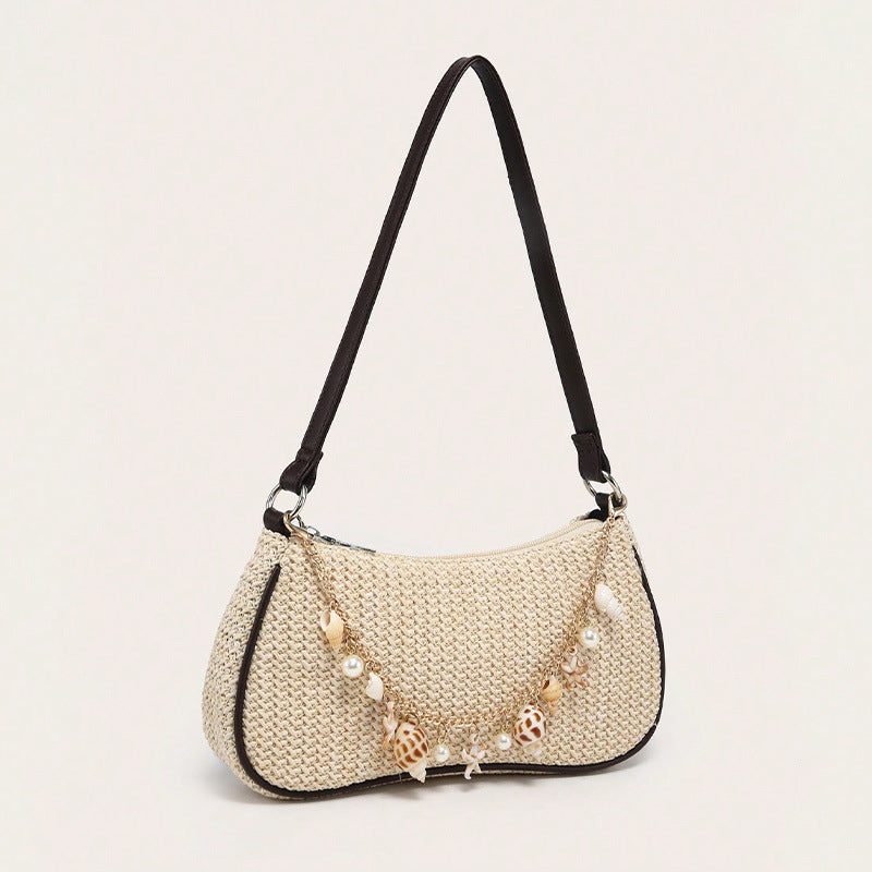 Florence pearl charm shoulder bag in black — on model