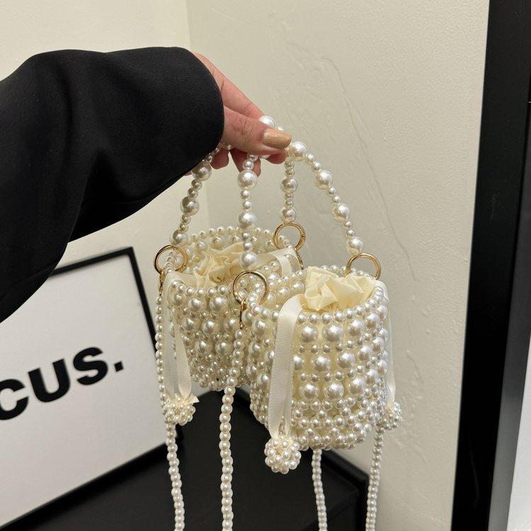 Isla faux-pearl bucket bag — on model