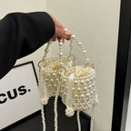 Isla faux-pearl bucket bag — on model