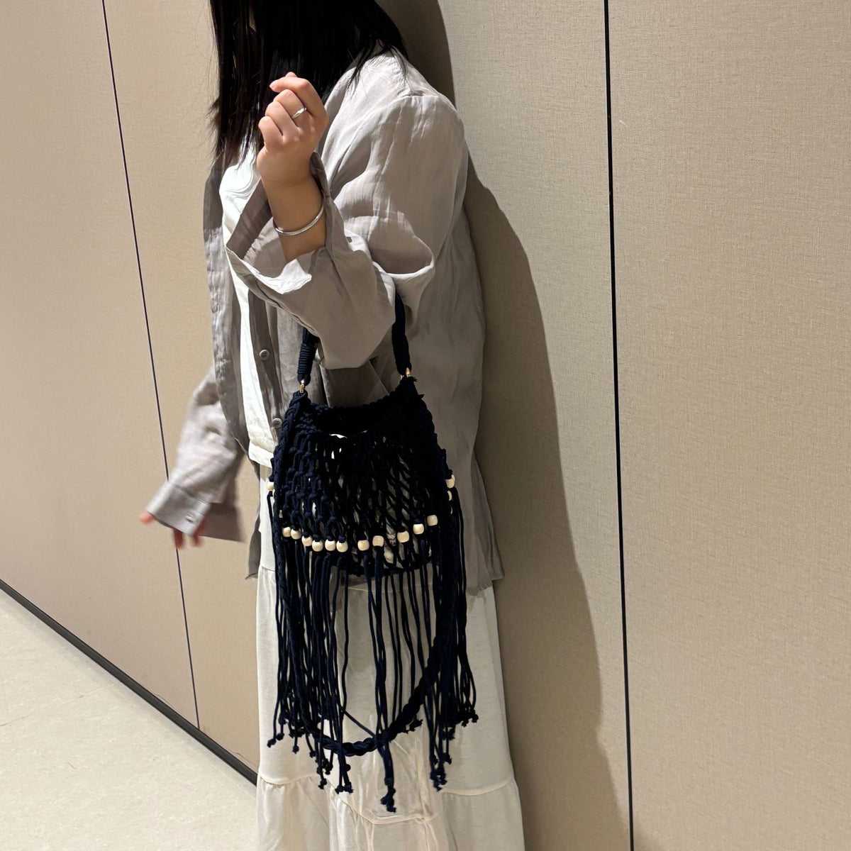 Juniper fringe crochet bag in black — on model