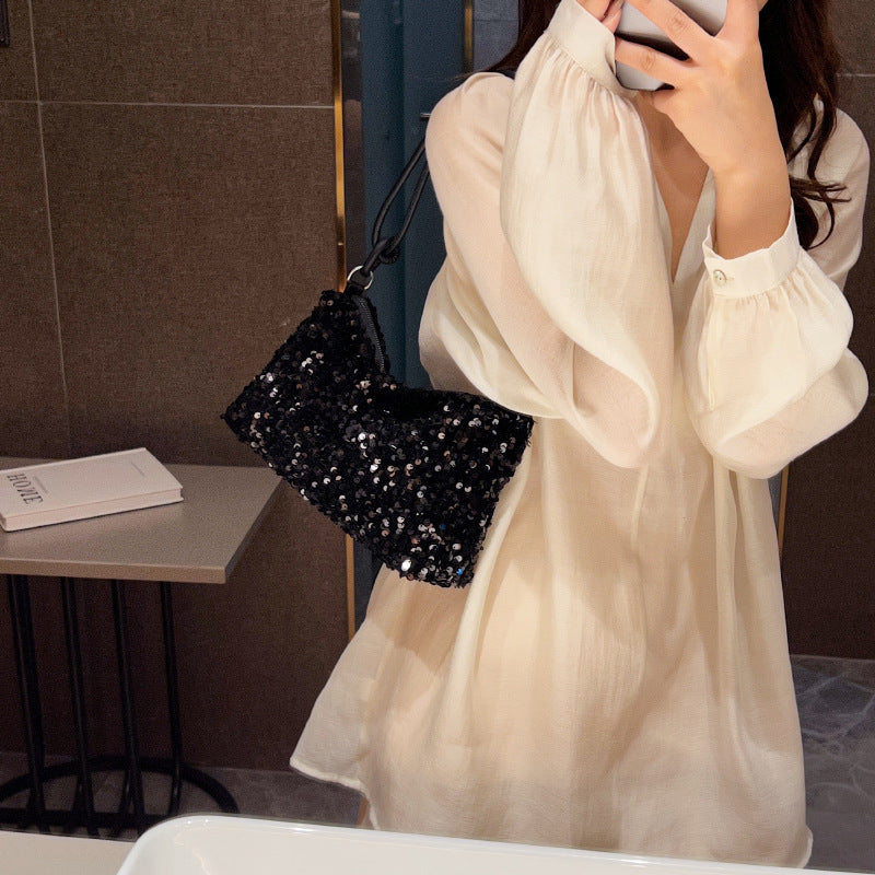 Giselle sequin shoulder bag in black — on model