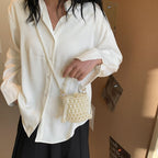Isla faux-pearl bucket bag — on model
