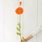 110cm Artificial Flower Stem in Orange — on model