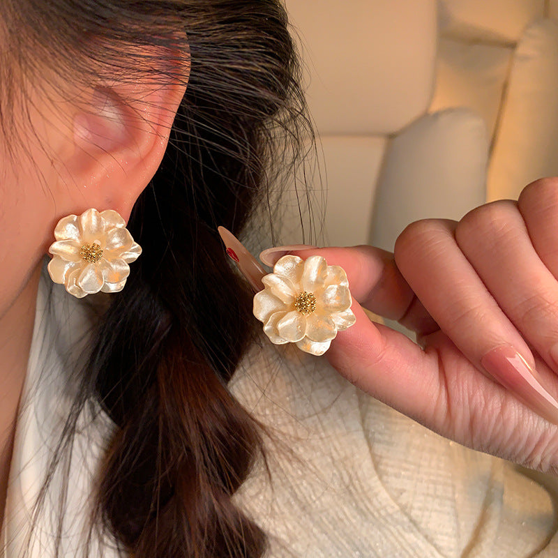 Pearl Bloom Stud Earrings — worn on ear