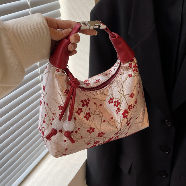 Camille blossom silk-look shoulder bag in red — on model