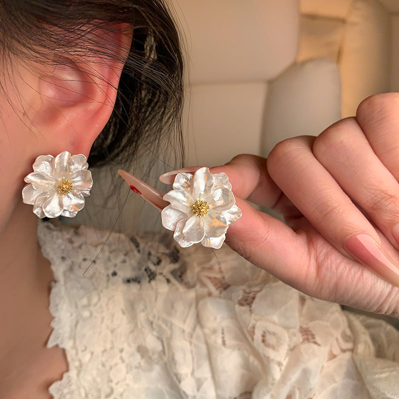 Pearl Bloom Stud Earrings — detail in hand