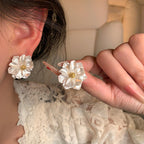 Pearl Bloom Stud Earrings — detail in hand