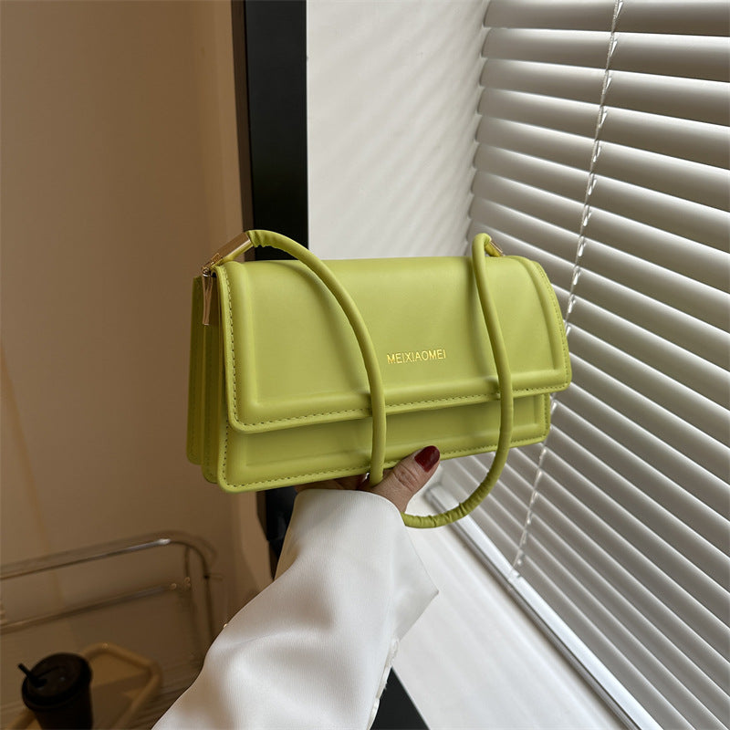 Harriet minimalist structured shoulder bag in green — on model