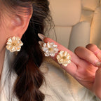 Pearl Bloom Stud Earrings — close-up on ear
