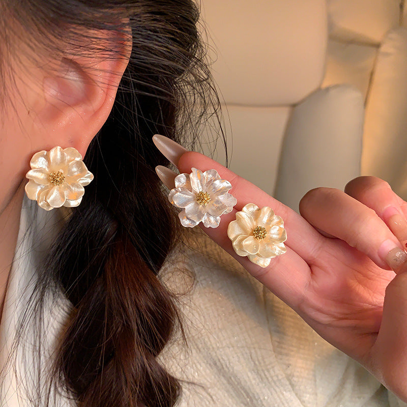 Pearl Bloom Stud Earrings — close-up on ear
