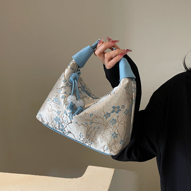 Camille blossom silk-look shoulder bag in blue — on model