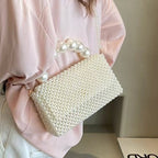 Celeste faux-pearl chain shoulder bag in ivory — on model, side view