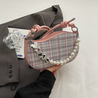 Amelie faux-pearl heart shoulder bag in pink — on model