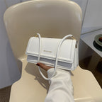 Harriet minimalist structured shoulder bag in white — on model