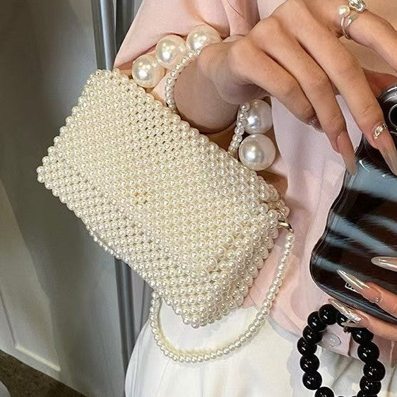 Celeste faux-pearl chain shoulder bag in ivory — on model, detail