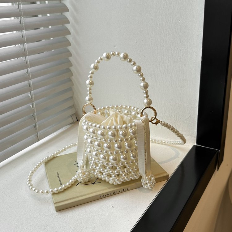 Isla faux-pearl bucket bag — styled