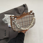 Amelie faux-pearl heart shoulder bag in brown — on model