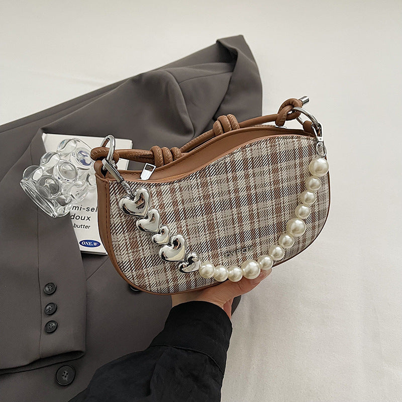 Amelie faux-pearl heart shoulder bag in brown — on model