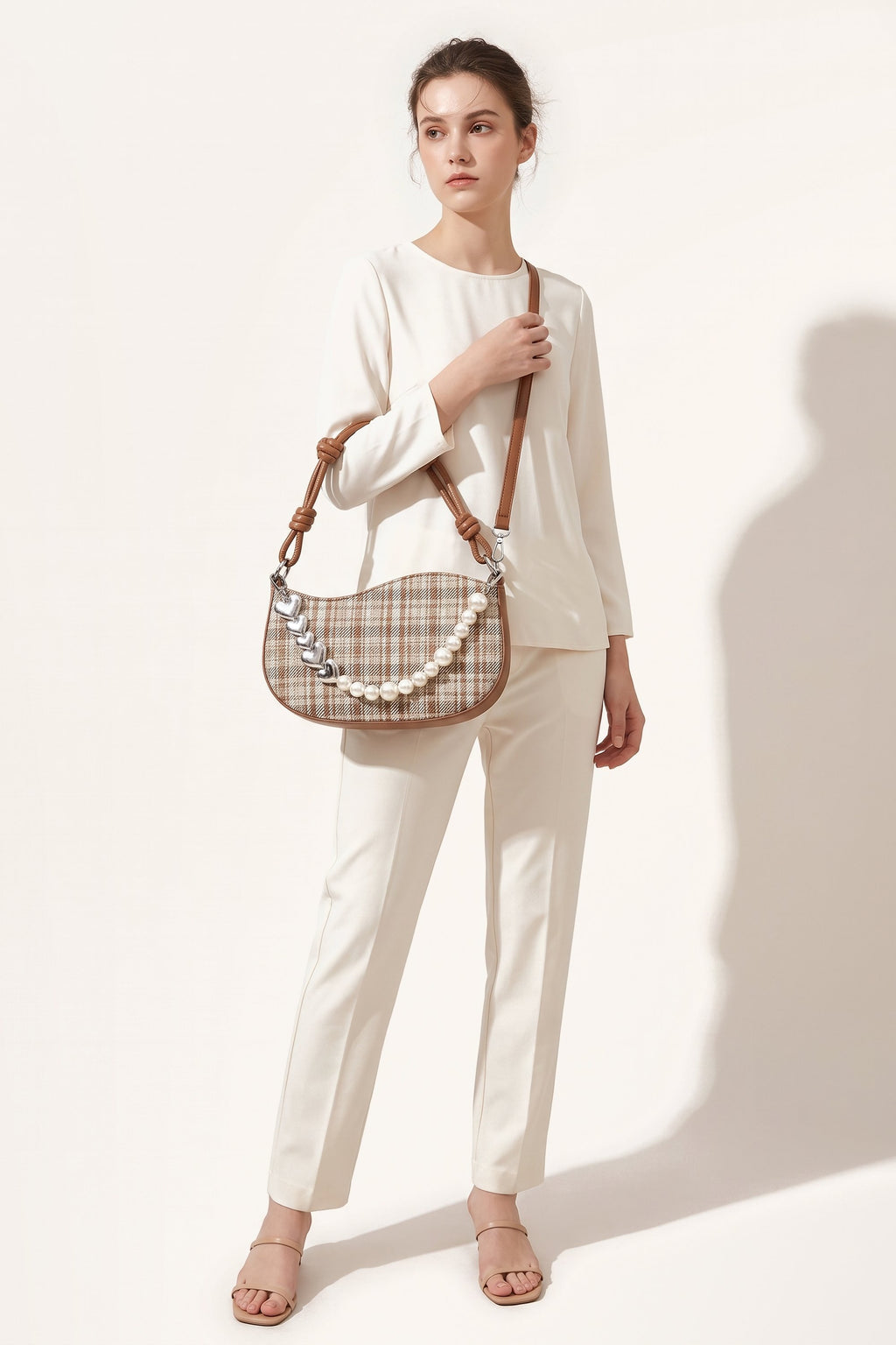 Amelie faux-pearl heart shoulder bag in brown — on model