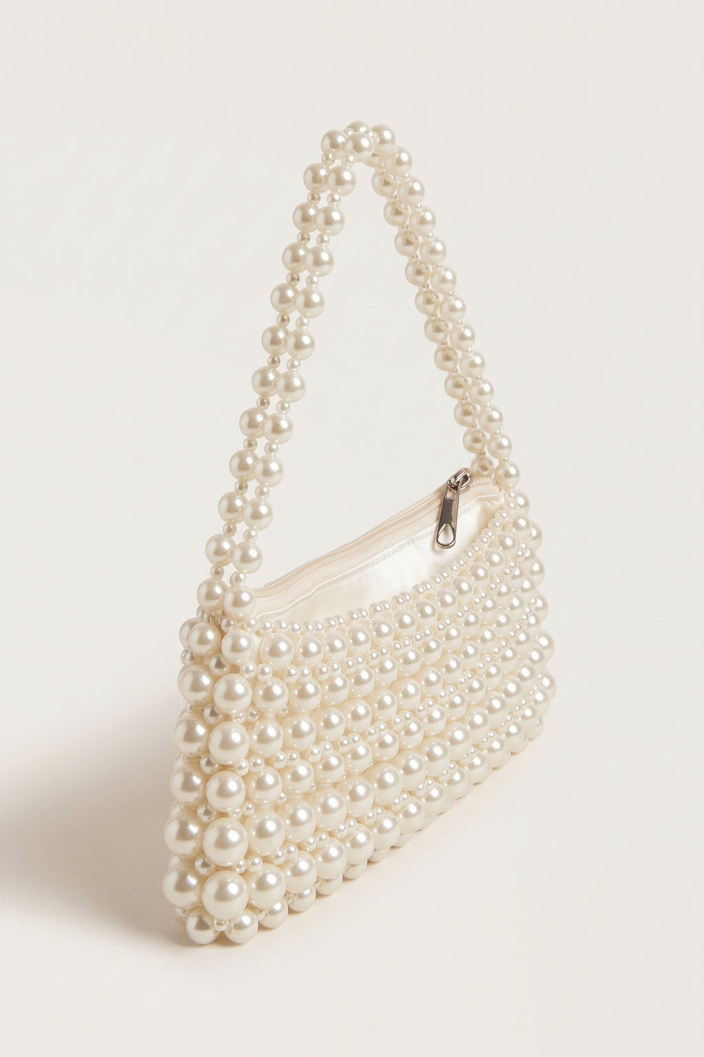 Beatrix faux-pearl shoulder bag in ivory — three-quarter view