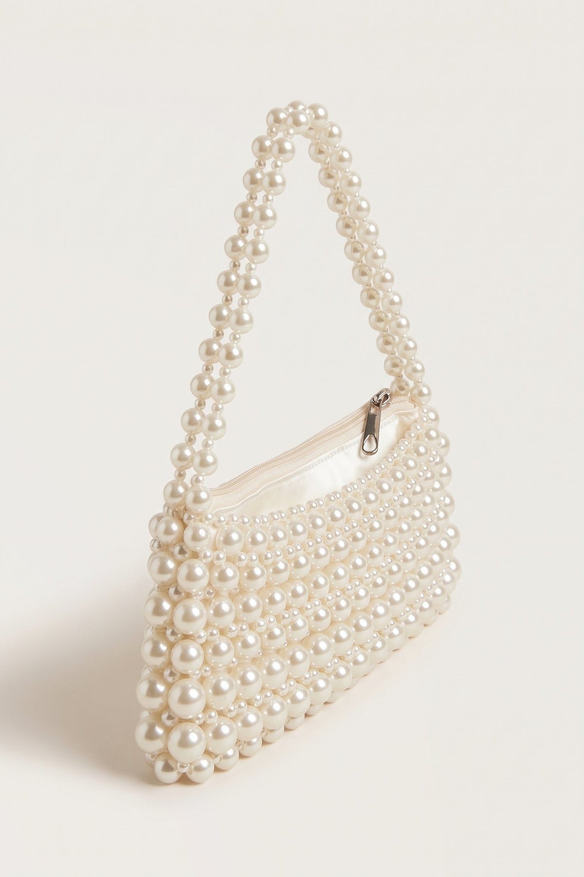 Beatrix faux-pearl shoulder bag in ivory — three-quarter view