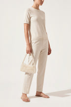 Beatrix faux-pearl shoulder bag in ivory — on model