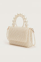 Celeste faux-pearl chain shoulder bag in ivory — three-quarter view