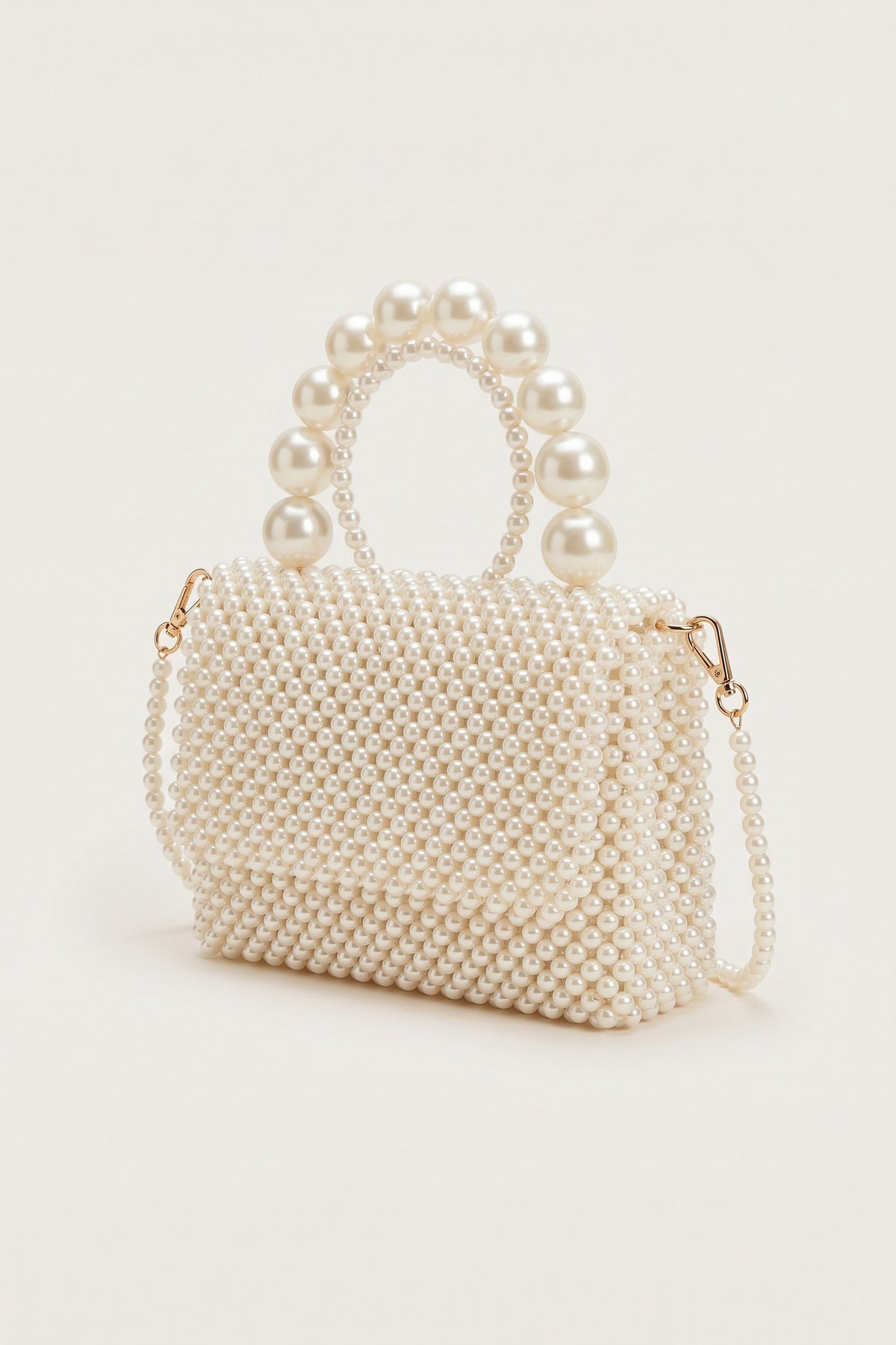 Celeste faux-pearl chain shoulder bag in ivory — three-quarter view