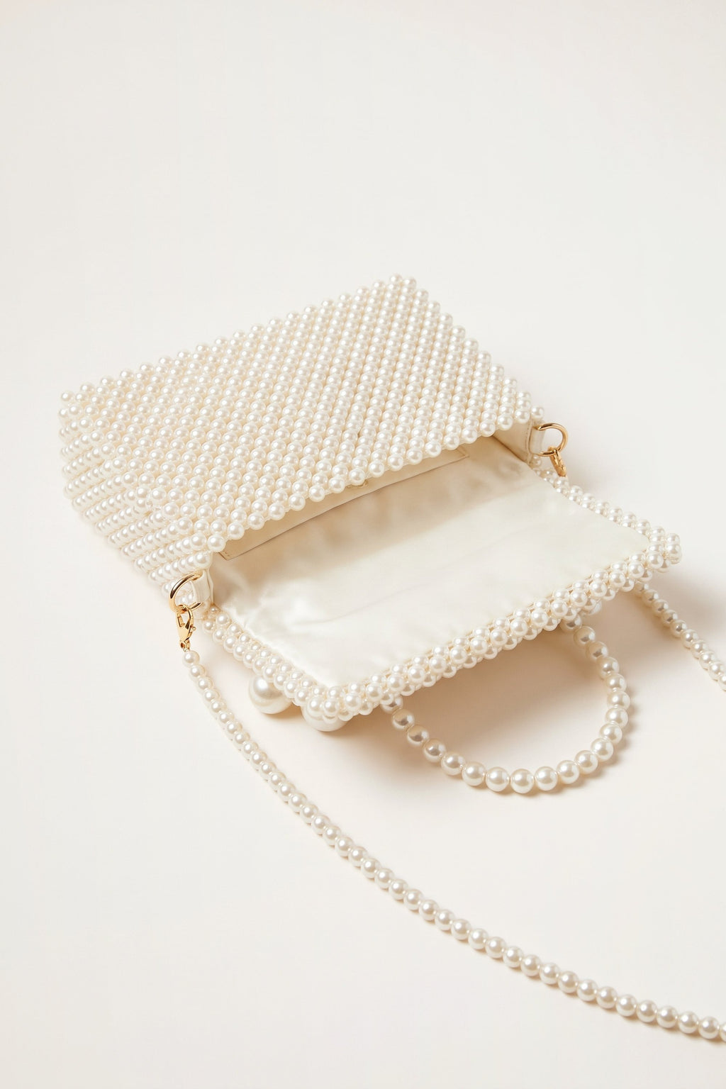 Celeste faux-pearl chain shoulder bag in ivory — open view