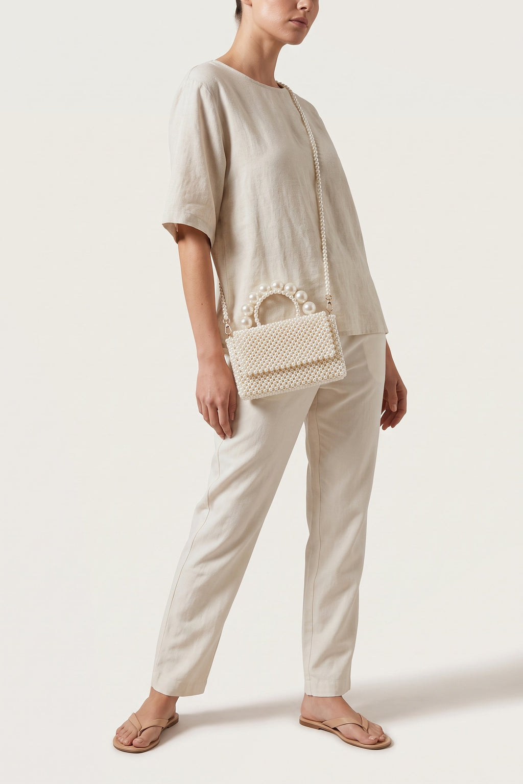Celeste faux-pearl chain shoulder bag in ivory — on model