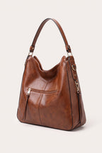 Genevieve hobo bag in brown — three-quarter view