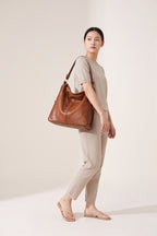Genevieve hobo bag in brown — on model