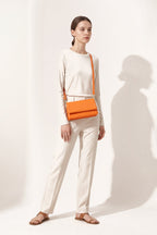 Harriet shoulder bag in orange — on model