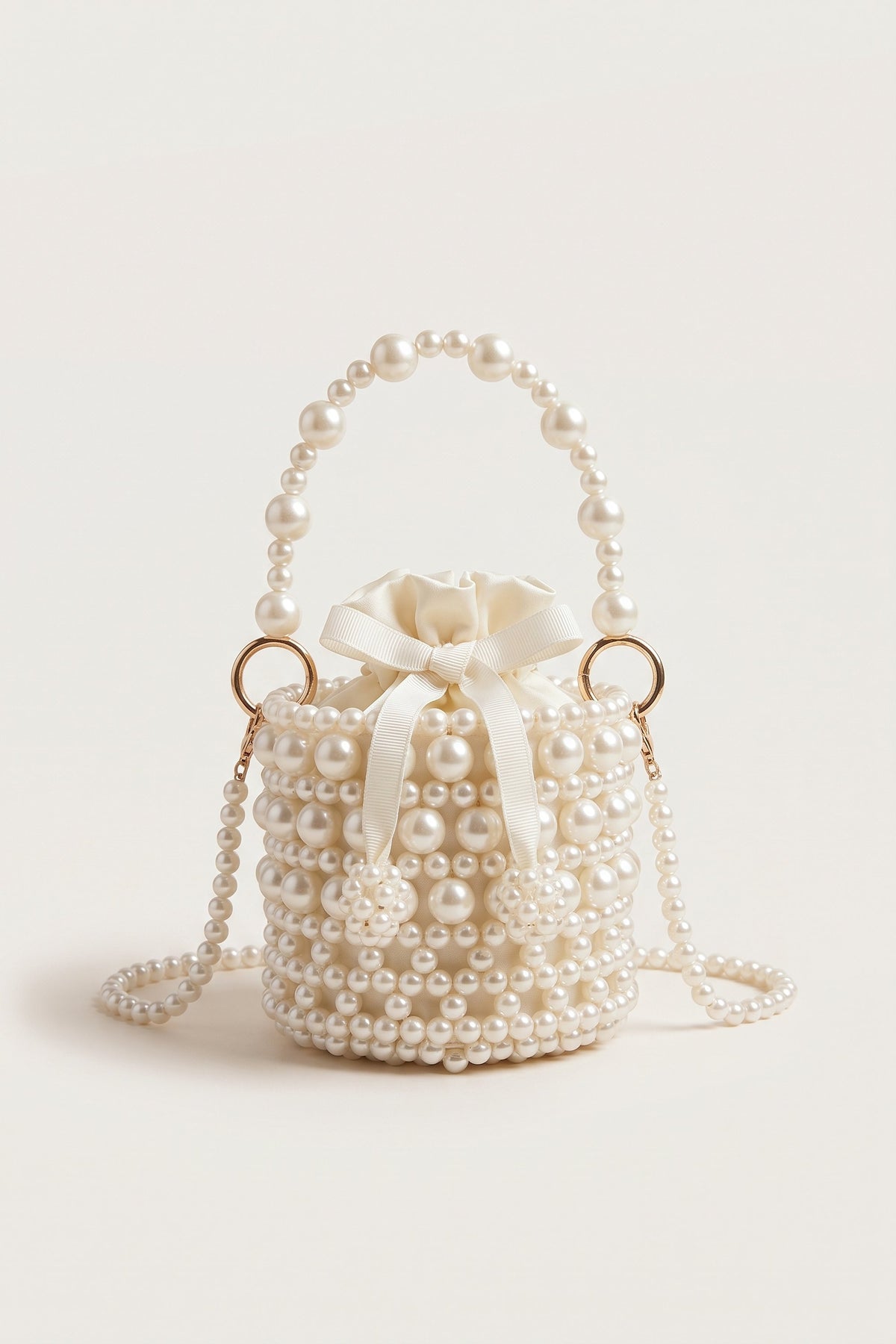 Isla faux-pearl bucket bag in ivory — front view