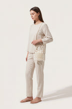 Isla faux-pearl bucket bag in ivory — on model