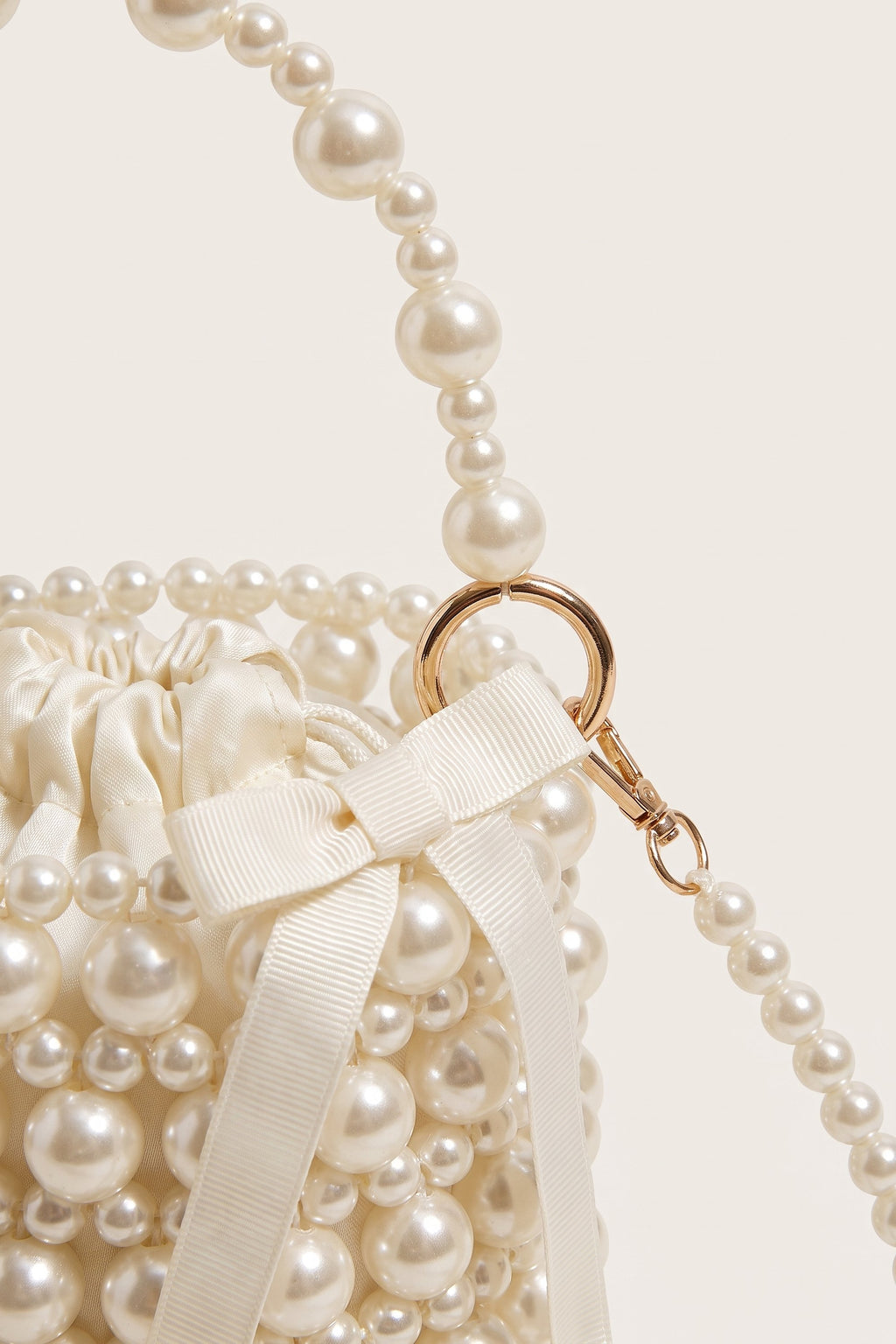 Isla faux-pearl bucket bag in ivory — detail