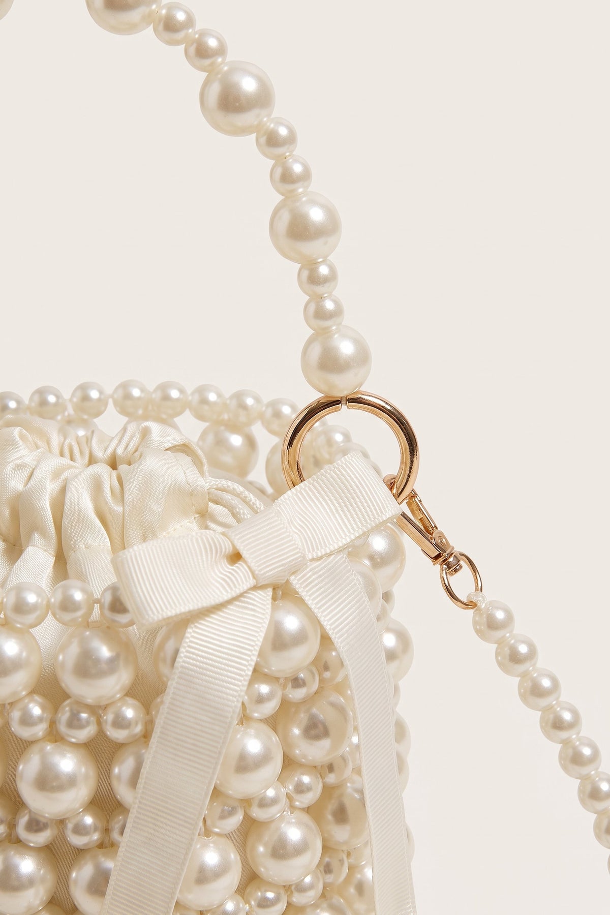 Isla faux-pearl bucket bag in ivory — detail