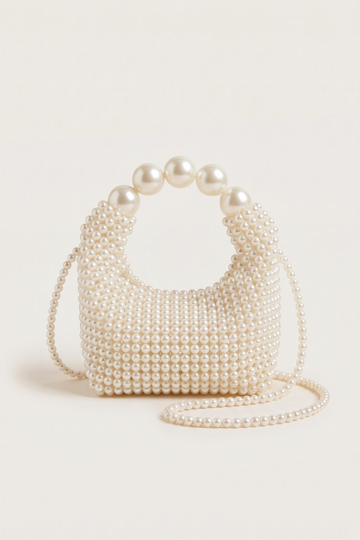Odette faux-pearl handbag in ivory — front view
