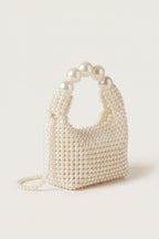 Odette faux-pearl handbag in ivory — three-quarter view