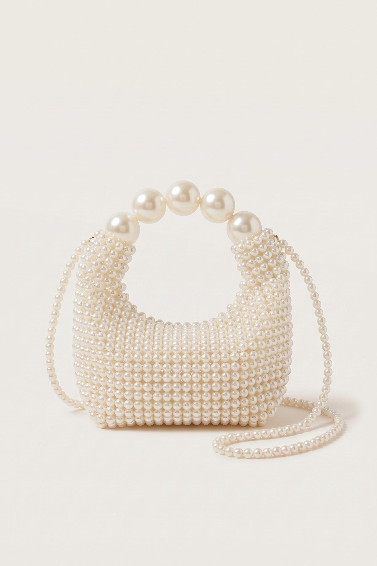 Odette faux-pearl handbag in ivory — side view