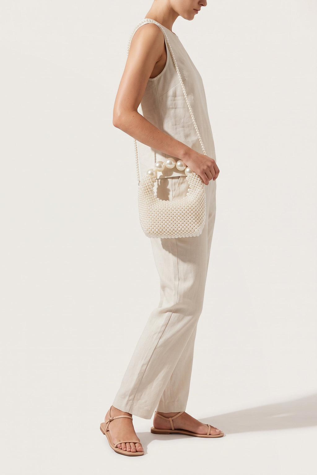 Odette faux-pearl handbag in ivory — on model