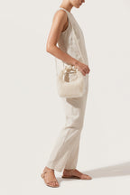 Odette faux-pearl handbag in ivory — on model