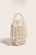 Perla crossbody bag in ivory — three-quarter view