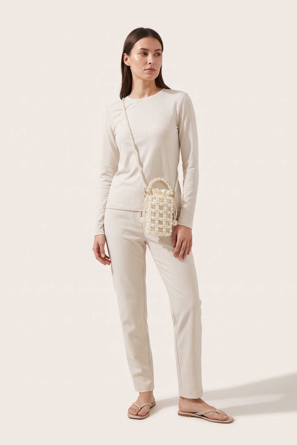 Perla crossbody bag in ivory — on model