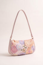 Primrose pastel floral embroidery shoulder bag in pink — three-quarter view