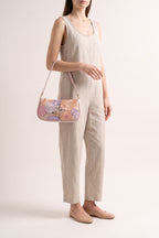 Primrose pastel floral embroidery shoulder bag in pink — on model
