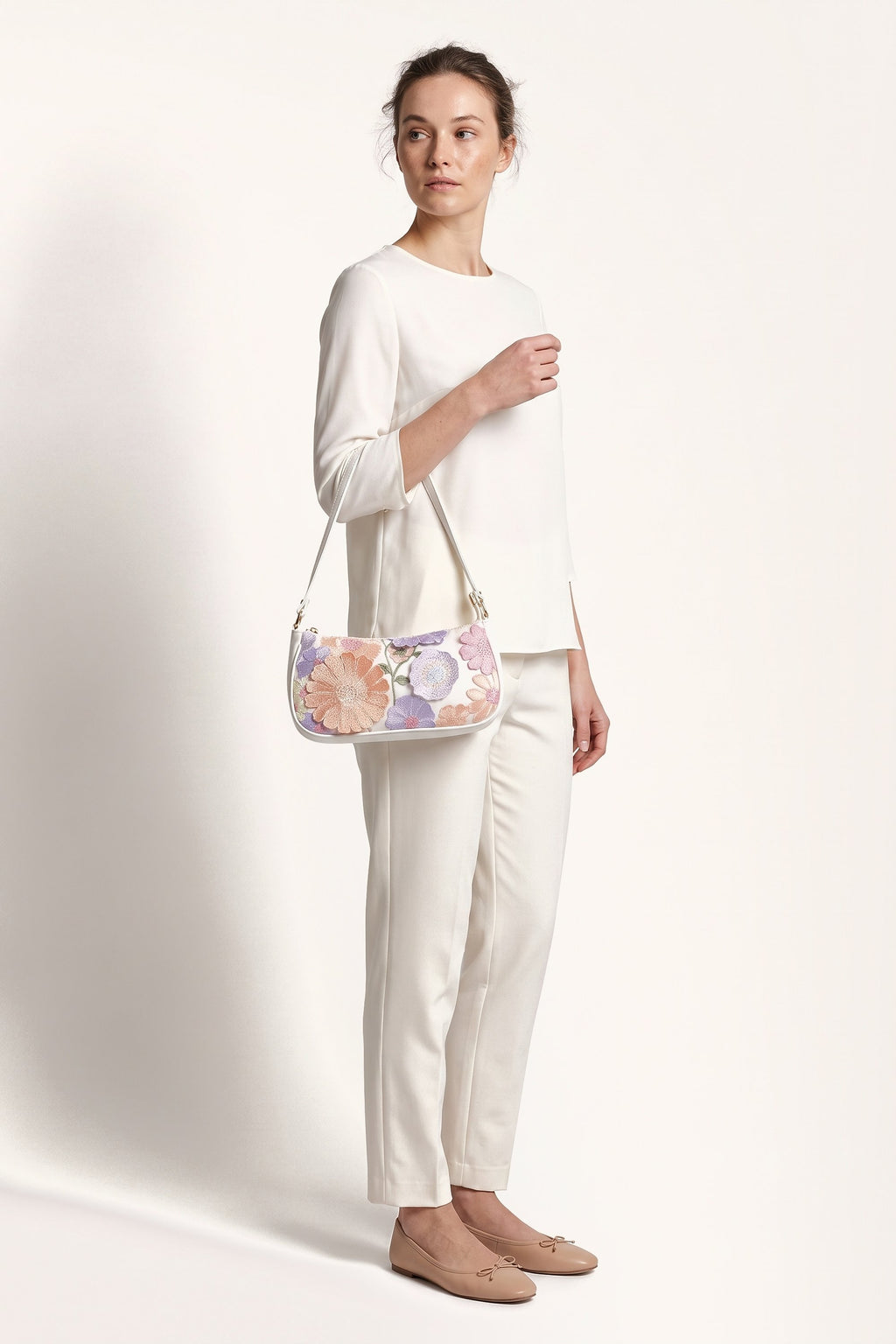Primrose pastel floral embroidery shoulder bag in white — on model